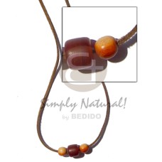 leather thong with horn cylinder and wood